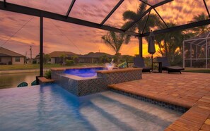 A heated pool, pool loungers - Canal Front Home w/ Salt Water Pool (Cape Coral)