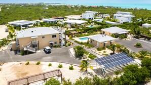 Ein Resort mit mehreren Gebäuden, einem Schwimmbad und einer Solaranlage.