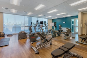 A gym with various exercise equipment, large windows, and a view of the outside. - Holiday Inn Express & Suites Phoenix Dwtn - State Capitol by IHG (Phoenix)