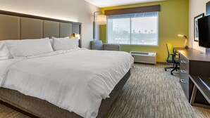 A hotel room with a large bed, a desk with a chair, a television, and a window with a view. - Holiday Inn Express & Suites Phoenix Dwtn - State Capitol by IHG (Phoenix)