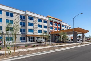 A Holiday Inn Express & Suites hotel with a modern design, featuring a covered entrance and a parking lot. - Holiday Inn Express & Suites Phoenix Dwtn - State Capitol by IHG (Phoenix)