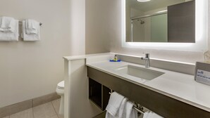 A modern bathroom with a white sink, a mirror, and a toilet. - Holiday Inn Express & Suites Phoenix Dwtn - State Capitol by IHG (Phoenix)