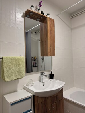 Bañera, secador de pelo, toallas y jabón