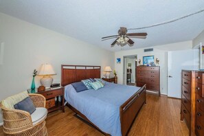 A bedroom with a bed, two bedside tables, a chair, a dresser, and a ceiling fan. - PA C-401 - Palma - Standard Plus (St. Petersburg)