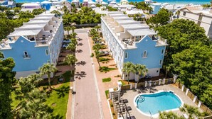 A resort with multiple-story buildings, a central pool, and a view of the ocean. - Ocean View Rooftop ☀️Heated Pool, 1 Minute to Beach, 4 Story Home ☀️ Beach Gear (Santa Rosa Beach)