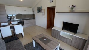 A modern apartment with a kitchen, dining area, and living room. - Deluxe apartment Jela 2 for 4 people with sea view (Sveti Vid Miholjice)