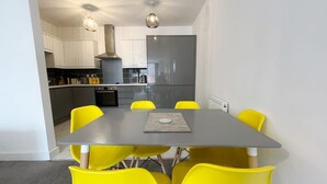A modern kitchen with white cabinets, a grey countertop, and a stainless steel refrigerator. - Anstey Heights - Apartment 8 - Hopewell (Easton)