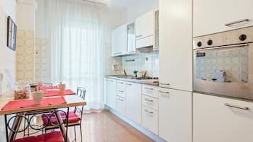 Apartment, 2 Bedrooms | Private kitchen | Full-sized fridge, oven, stovetop, cookware/dishes/utensils