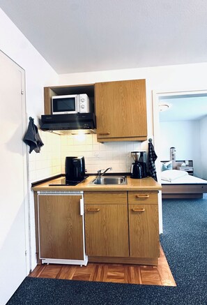 Kühlschrank, Mikrowelle, Herdplatte, Wasserkocher mit Kaffee-/Teezubehör