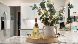 A kitchen counter with a tray holding a bottle, a glass jar, and a pitcher. - 6BR! Sleeps 15+ Htd Pool, putting green, Theater, game rm, 5 mi to beaches, AMI (Bradenton)