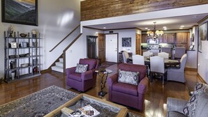 A spacious living area with a wooden ceiling, a staircase, a dining area, and a kitchen. - 'Elevation Station' at 5100 ft w/ Panormic Views (Sugar Mountain)