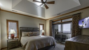 A bedroom with a bed, nightstands, a TV, a ceiling fan, and a large window with curtains. - 'Elevation Station' at 5100 ft w/ Panormic Views (Sugar Mountain)