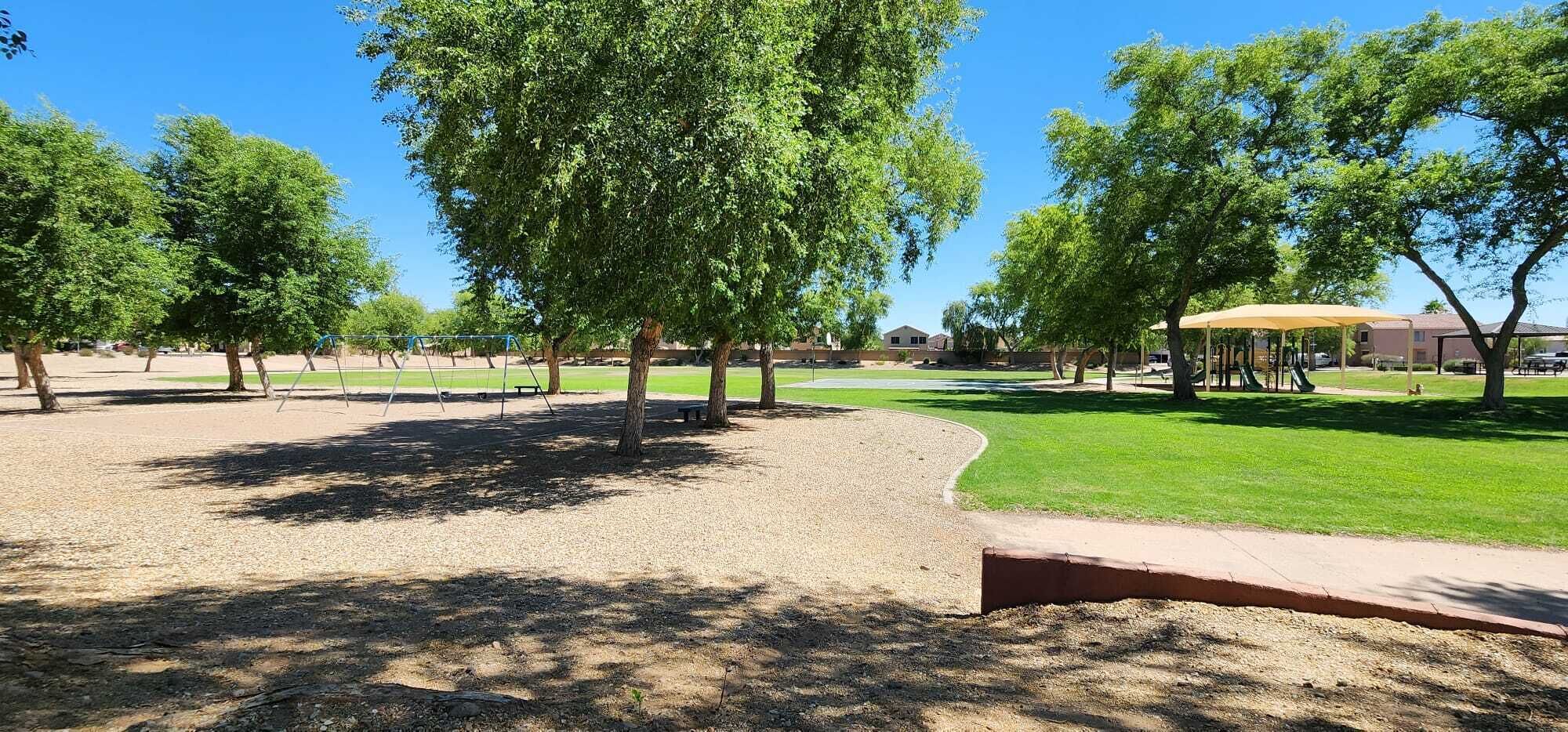 A park with a playground, picnic areas, and a covered seating area.