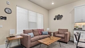 A living room with a brown sofa, two armchairs, a wooden coffee table, and a small side table. - Work Here!! King Bed, 400+ Mbps WiFi, BYU (Provo)