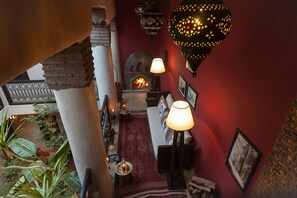 Cozy space with a fireplace, comfortable seating area, and staircase to an upper level.