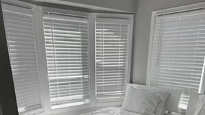 A hotel room with two beds, white bedding, and large windows with blinds. - Tropical Modern Oasis With Fully Fenced Yard 22409 (Hayward)