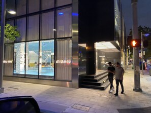 A modern building with large glass windows and a visible entrance.