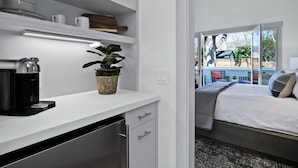 A modern kitchen with white cabinetry, a coffee machine, and a potted plant. - The Atlas Calistoga - Cottage #2 (Calistoga)