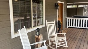 A porch with two rocking chairs and a table, a window, and a white railing. - On the river close to all adventure and short drive to Durango (D&S Train/Mesa Verde/Million Dollar HWY) (Bayfield)
