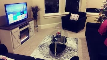 Smart-tv, een open haard, een kantoor en een printer