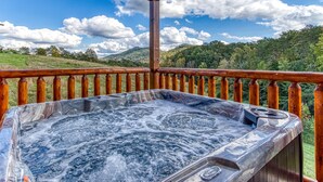 A hot tub on a wooden deck with a view of a mountainous landscape. - Modern Smoky Mtn Cabin, Hot Tub, Game Room, Pool Table, Near Dollywood (Sevierville)