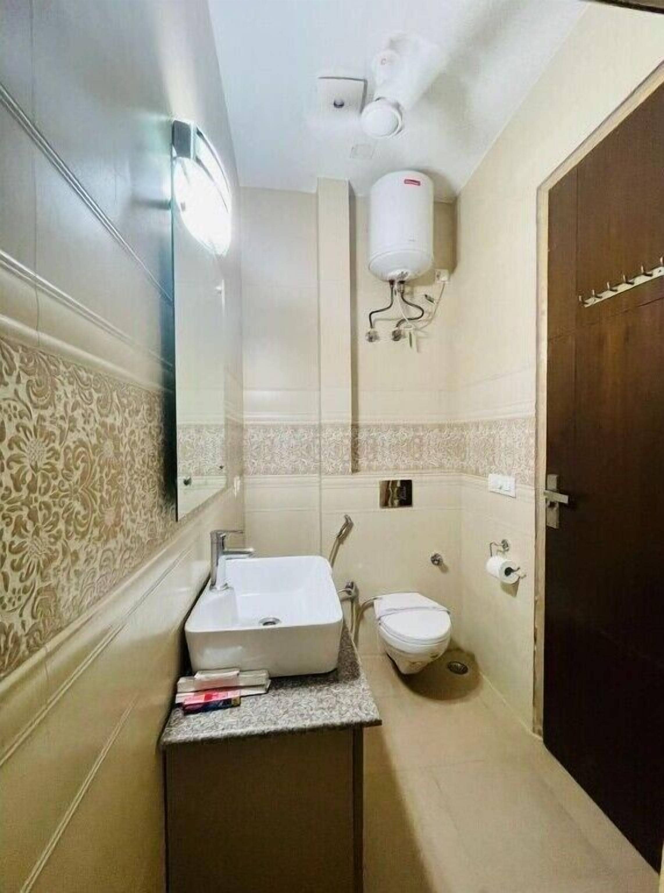 Casa de banho compacta com lavatório, sanita e porta-toalhas.
