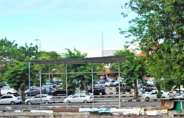 A parking lot with multiple cars and a covered area. - Griya Melati (Sidoarjo)