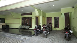 A covered parking area with several motorcycles parked. - Soerabaja Place Guest House (Surabaya)