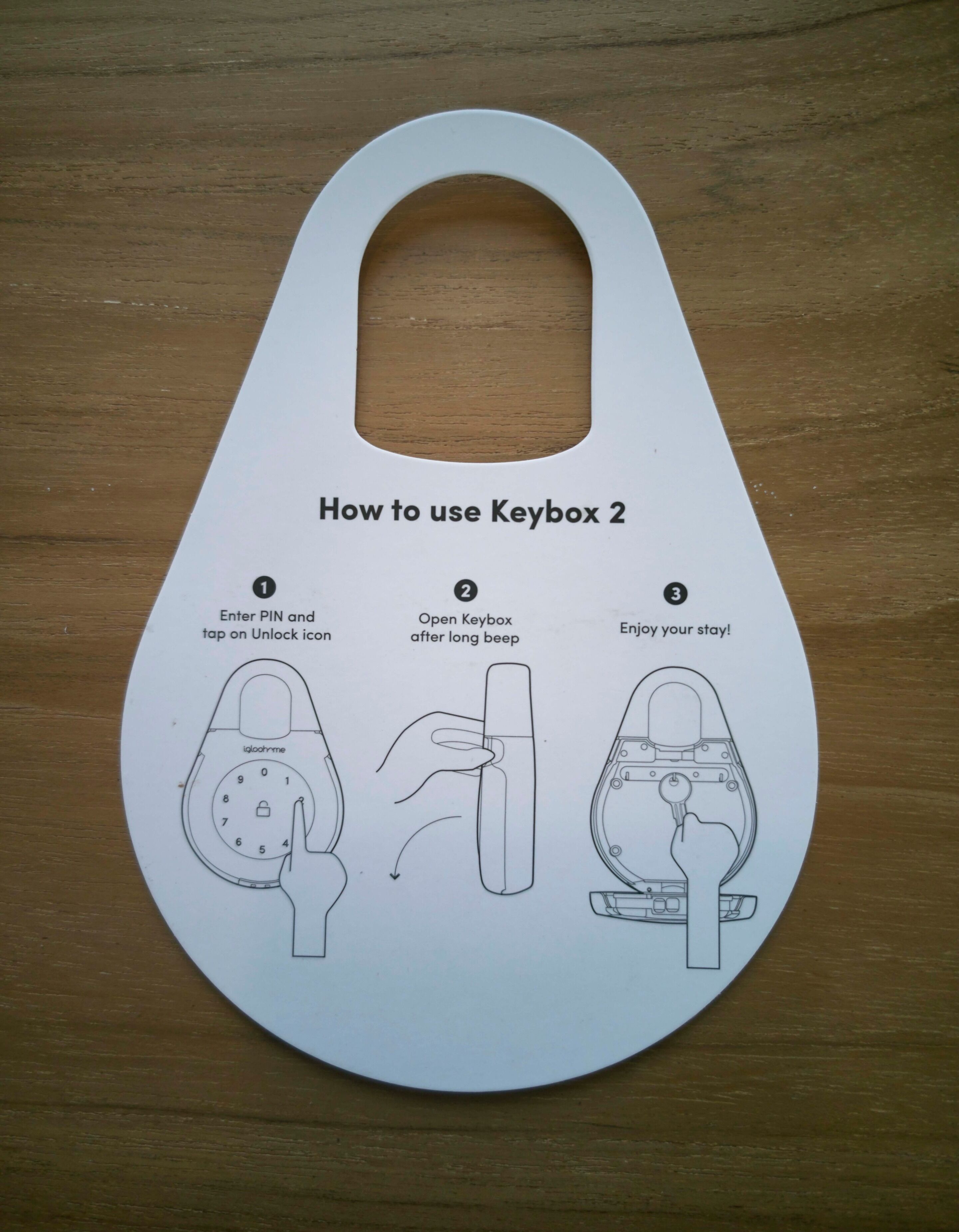 A white Keybox 2 instructional guide on a wooden surface.