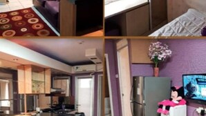 A room with a purple sofa, a small table, a mirror, and a window with blinds. - Apartment Gading Nias Residence (Jakarta)