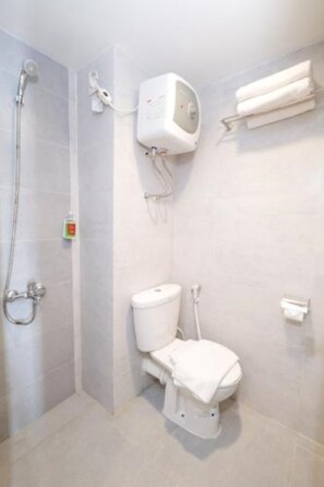 A bathroom with a shower, toilet, and a towel rack.