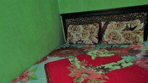 A bed with floral bedding and a headboard.