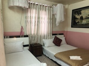A hotel room with two beds, a nightstand, a small cabinet, and a painting on the wall. - Bich Khue Hotel (Lam Vien - Da Lat)