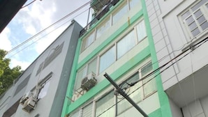 A multi-story building with several air conditioning units attached to the exterior walls. - Hoang Yen Nhi Hotel (Ho Chi Minh City)