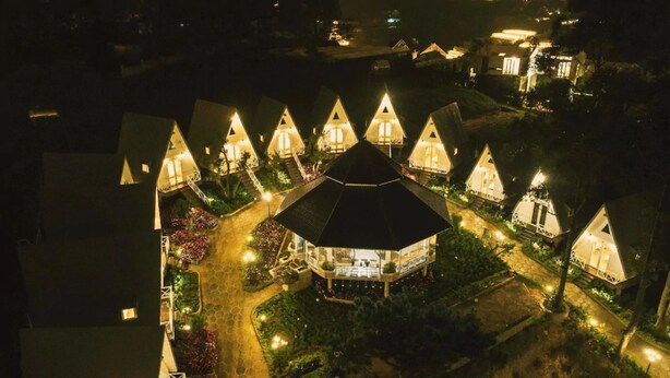 A series of triangular-roofed buildings with a central octagonal structure, surrounded by landscaped gardens and pathways. - Bungalow Lam Phuong Cac Hill (Xuan Truong - Da Lat)