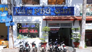 A hotel named 'PHU GIA' with motorcycles parked in front. - Phu Gia Hotel (Phu Thuy)
