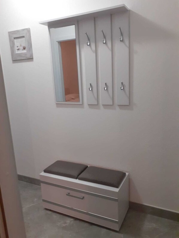 A room with a white vanity, a mirror, and a medicine cabinet with multiple compartments. - Apartments Seagull (Postira)