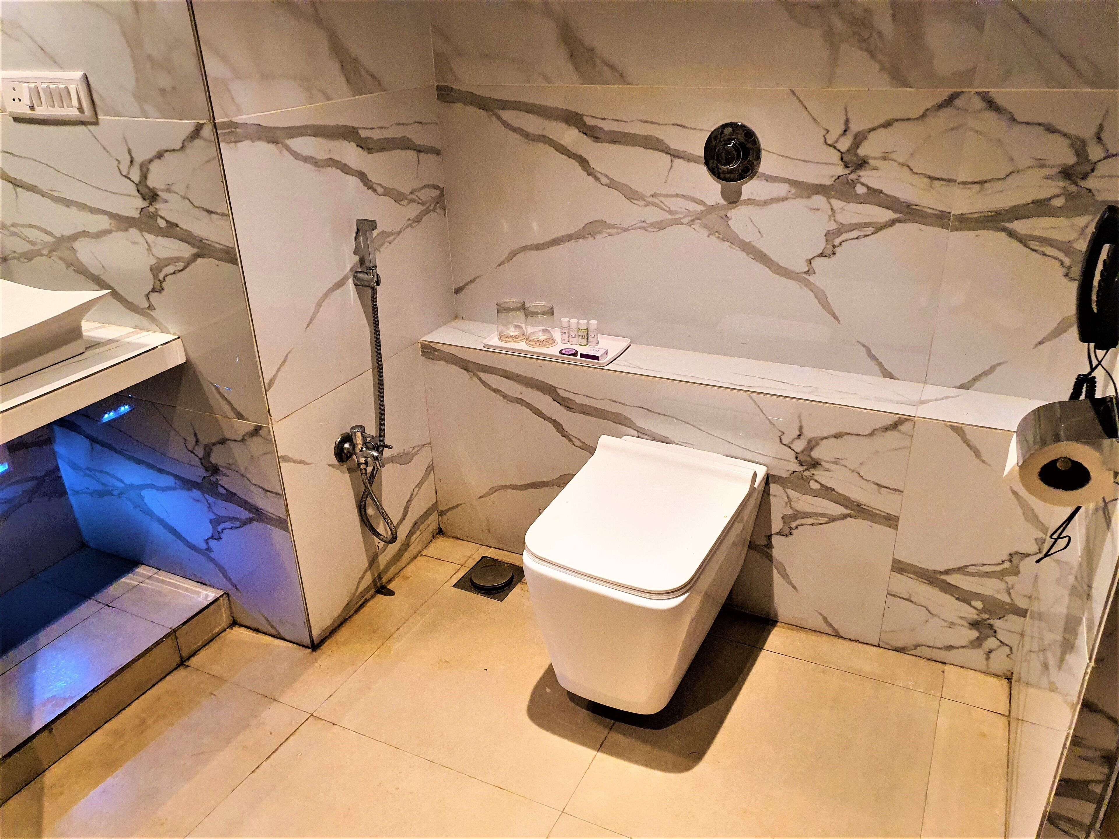 A bathroom with a toilet, a shower, and a sink.