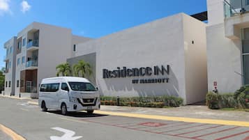 A white van parked in front of a building with a sign that reads 'Residence Inn by Marriott.'