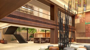 A spacious lobby with a modern staircase, seating areas, and decorative elements. - Lemon Tree Premier Vijayawada (Vijayawada)