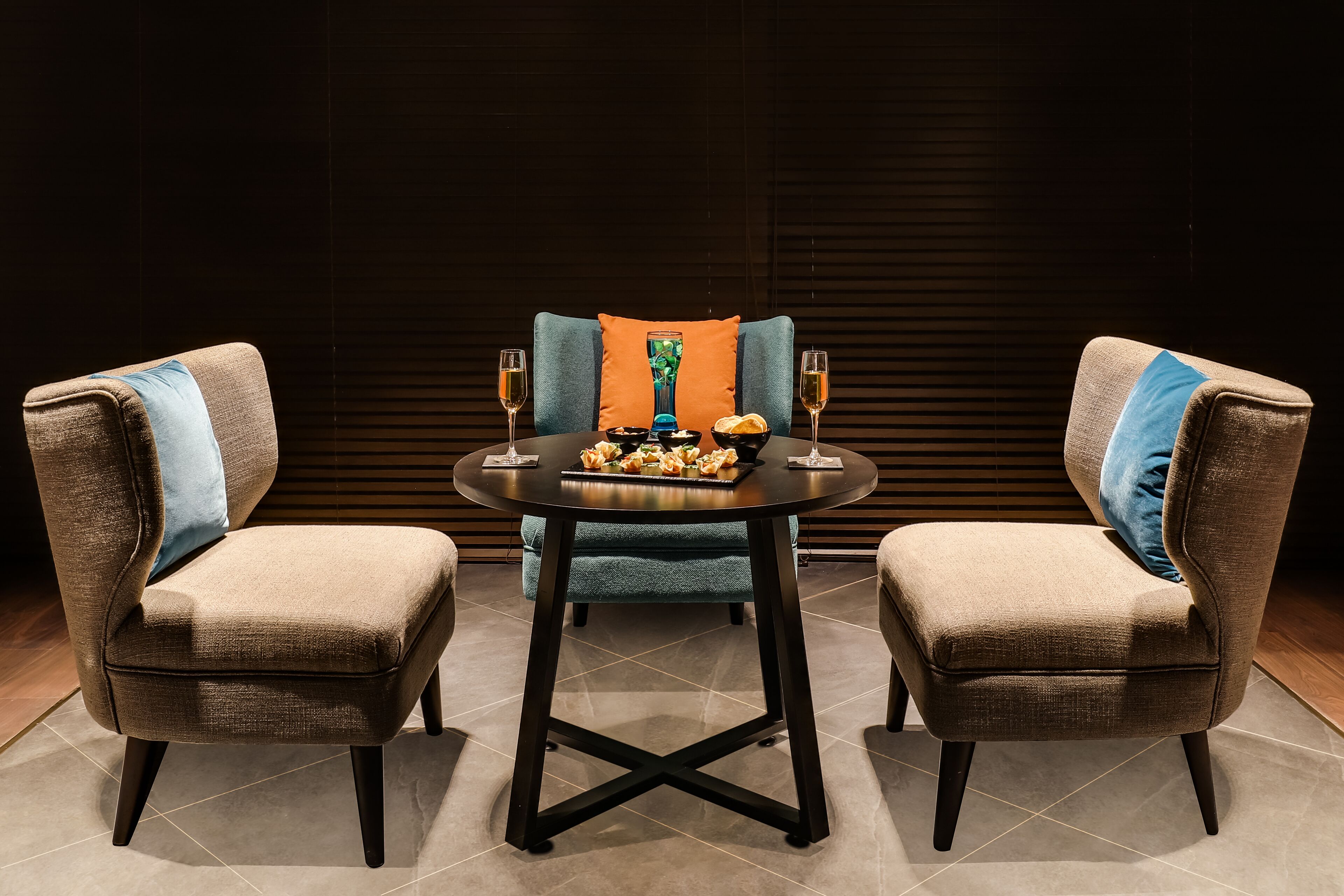 A dining area with a round table, two chairs, and a decorative centerpiece.