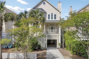 A two-story house with a front porch and a covered entryway.