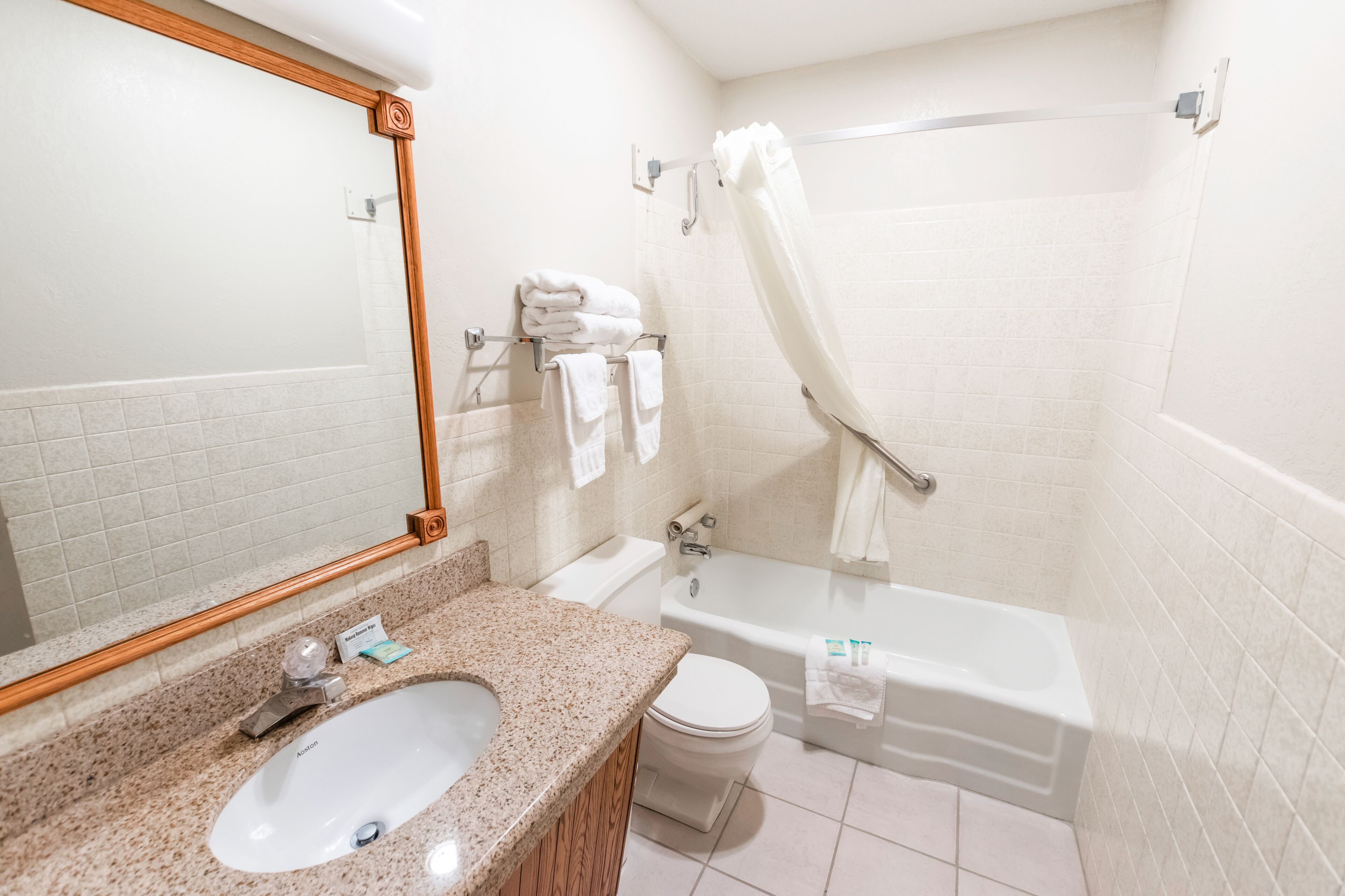 A bathroom with a sink, toilet, and bathtub.