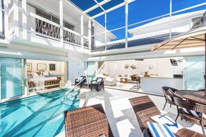 A heated pool, sun loungers