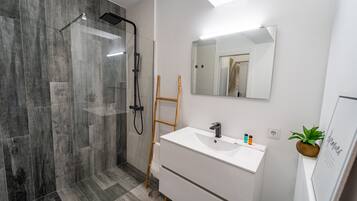 Shower, hair dryer, towels, toilet paper