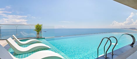 Outdoor pool, open 6:00 AM to 9:00 PM, sun loungers
