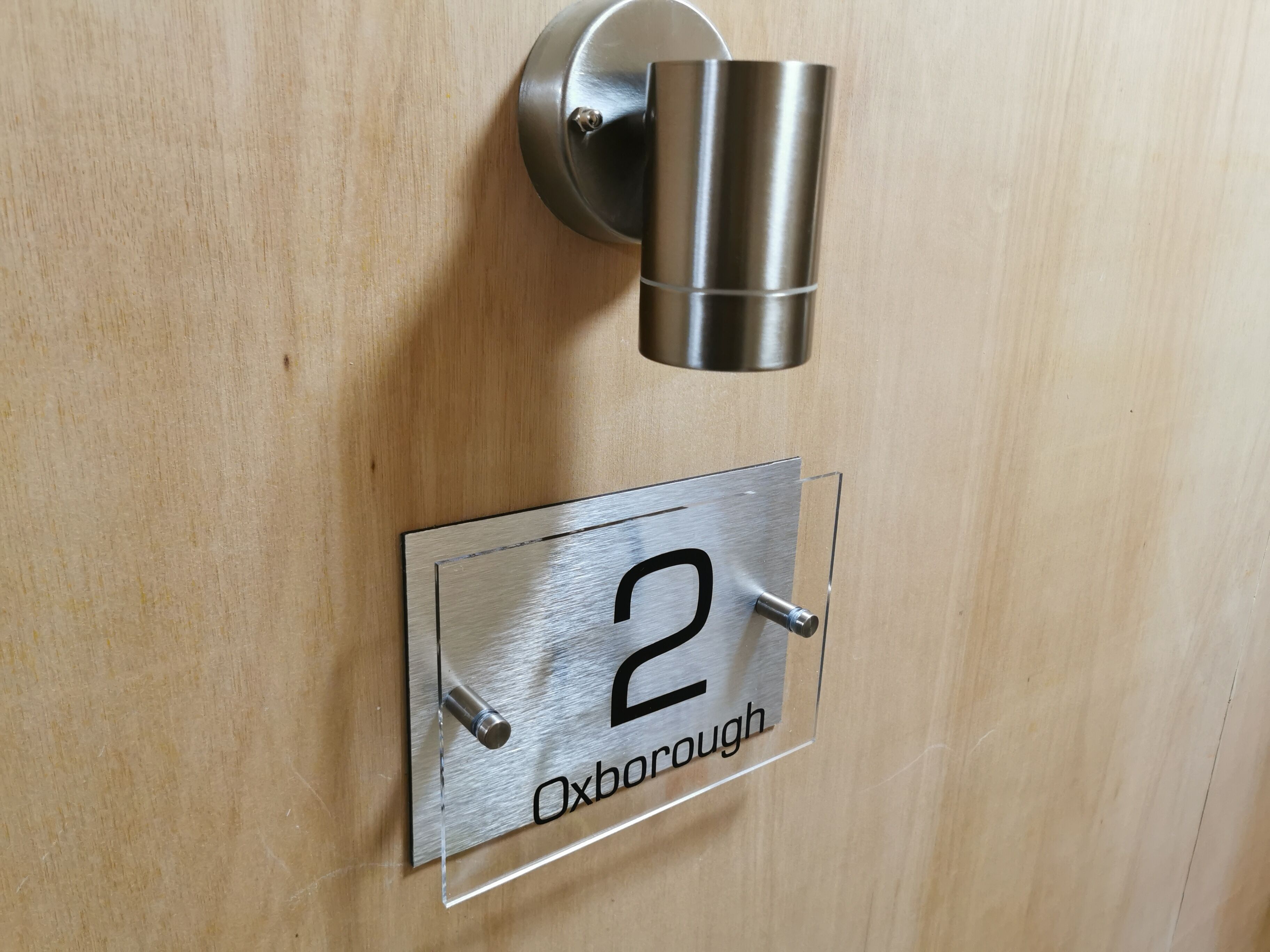 A door with a number plate labeled "2" and "Oxborough".