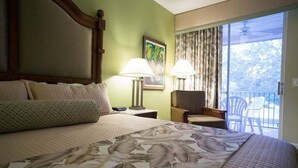 A hotel room with a large bed, two bedside lamps, a chair, and a balcony with a view. - 2022 Dec23-30 2 BD/2BA 0.8 mi to Disney World at Cypress Pointe Resort (Orlando)