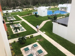 Relax in a serene outdoor space with a swimming pool, lounge chairs, and a beautifully manicured lawn.