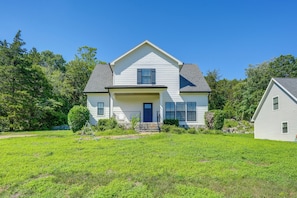 A two-story house with a front porch, a small front yard, and a neighboring building. - Scenic Mtn Retreat w/ Wooded Backyard + Fire Pit! (Chattanooga)